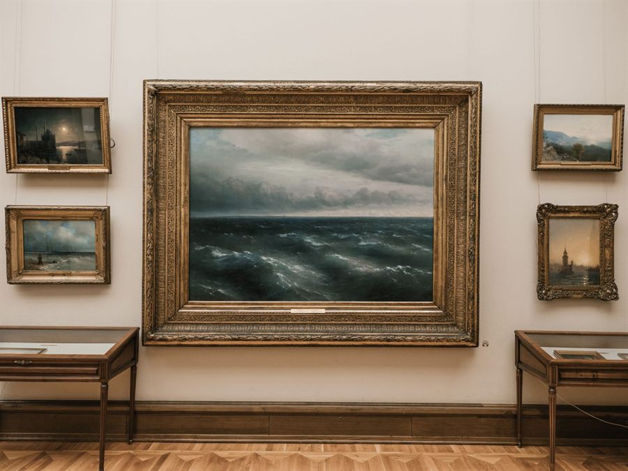 Large framed seascape painting hanging in a gallery