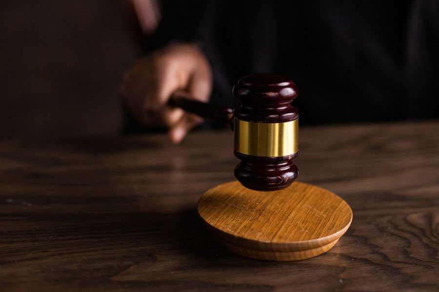 Wooden gavel resting on its block on a desk
