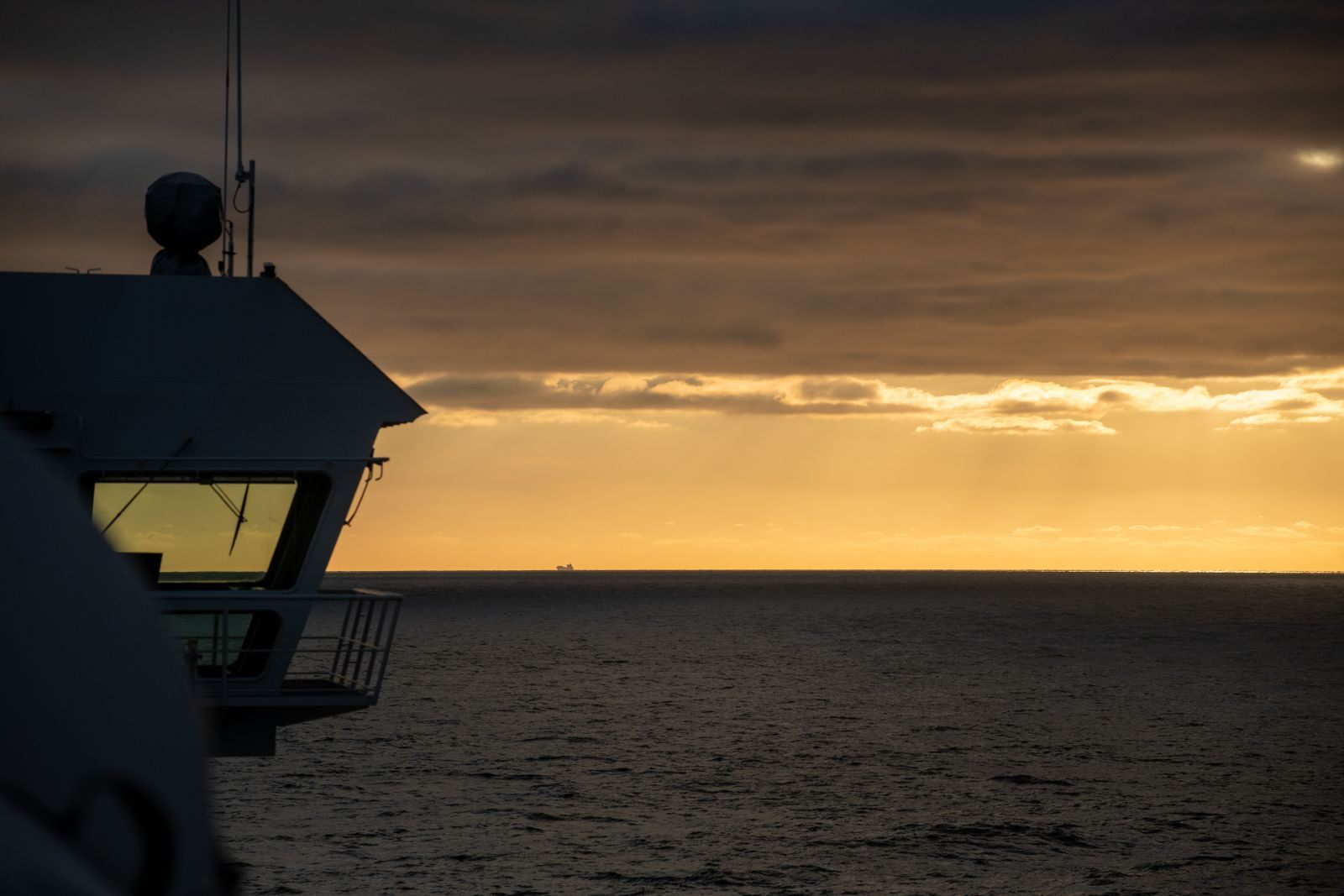 Golden sunset over the sea seen from a ship’s upper deck, the view an MSC cruise upgrade bid can bring closer