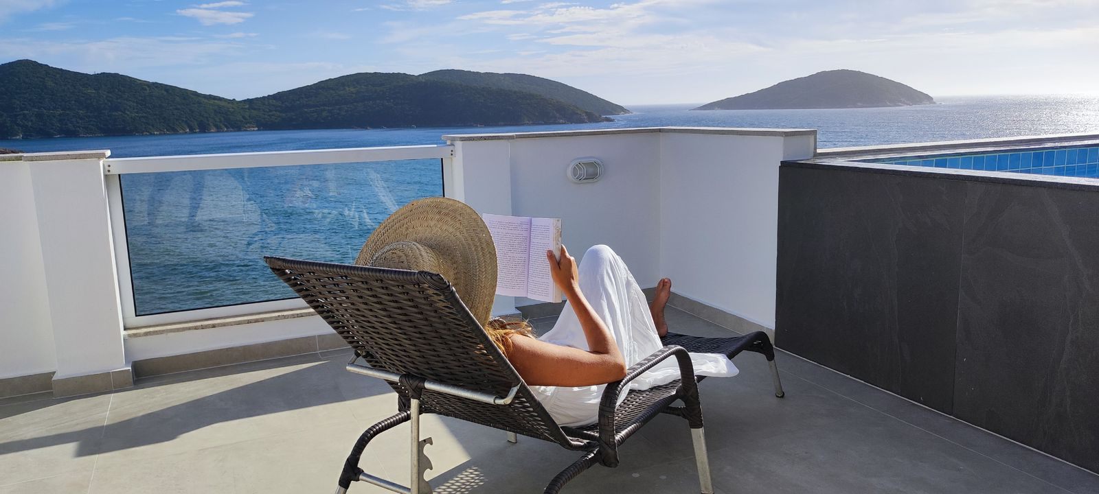 Guest reading on a lounger on a private sea-view deck, the kind of space a Princess cruise upgrade bid aims for